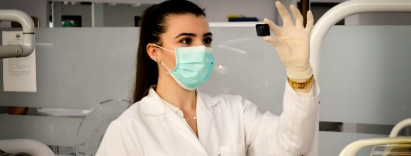 Girl in a lab inspecting a subject.
